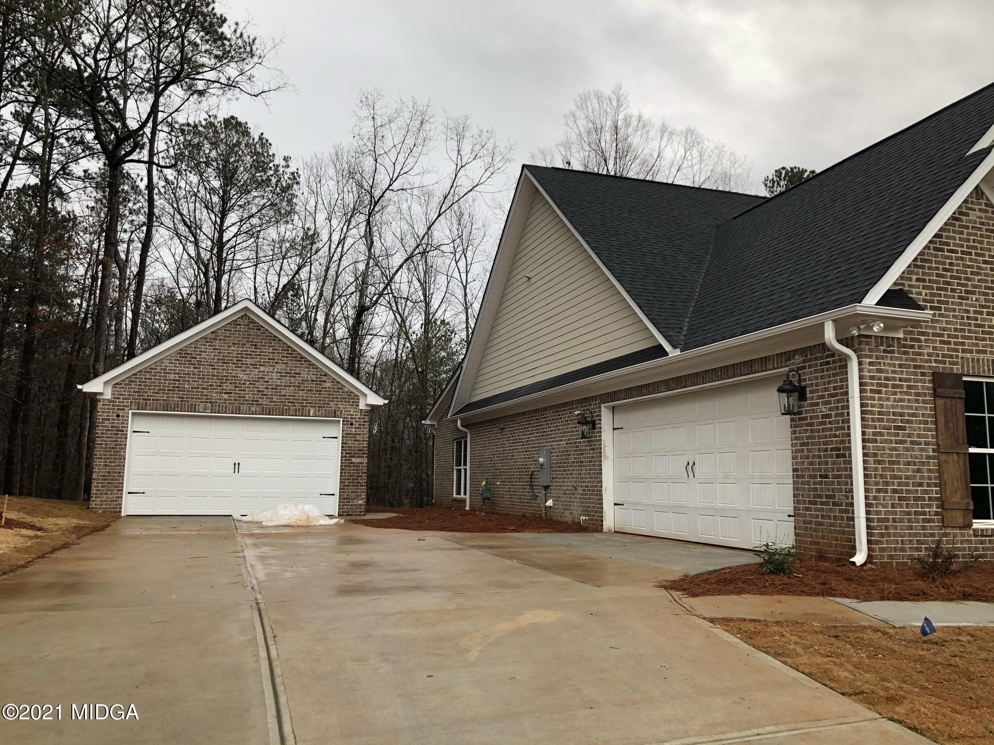 85 Adam Drive Forsyth, GA 31029 - Photo 16 of 18 a house with trees in front of it