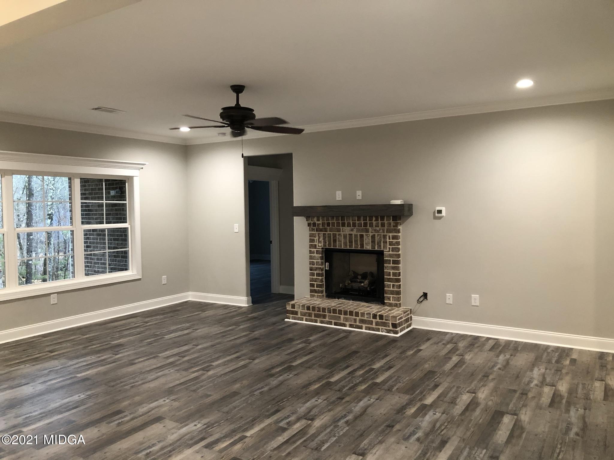 85 Adam Drive Forsyth, GA 31029 - Photo 3 of 18 an empty room with windows and fireplace
