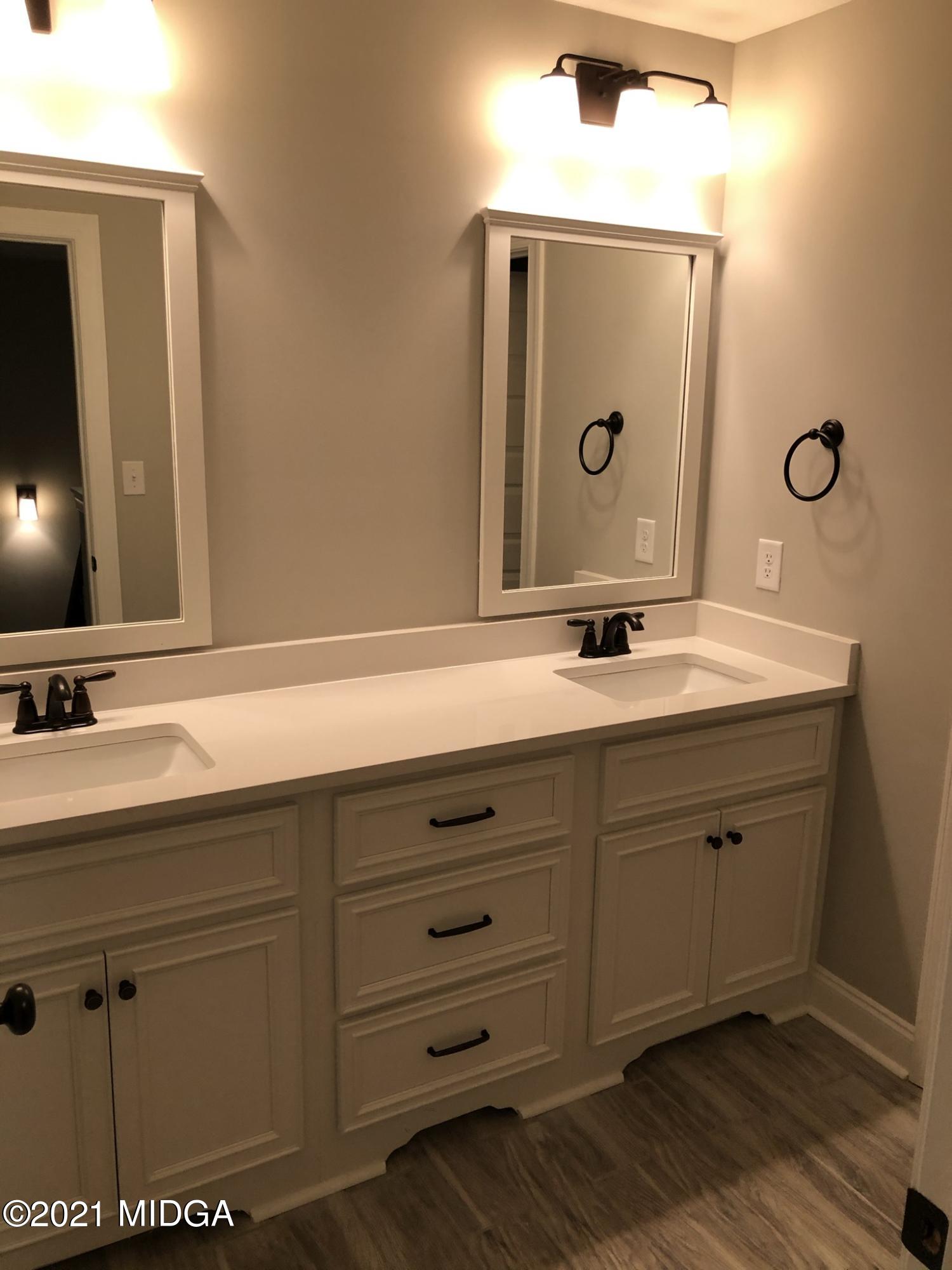 85 Adam Drive Forsyth, GA 31029 - Photo 6 of 18 a bathroom with a sink mirror and vanity
