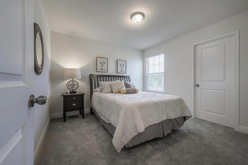 10128 Newel Valley Loop Riverview, FL 33569 - Photo 16 of 26 a bedroom with a bed and a night stand