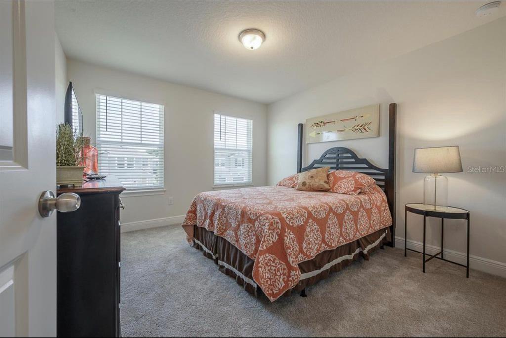 10128 Newel Valley Loop Riverview, FL 33569 - Photo 18 of 26 a bedroom with a bed and a lamp