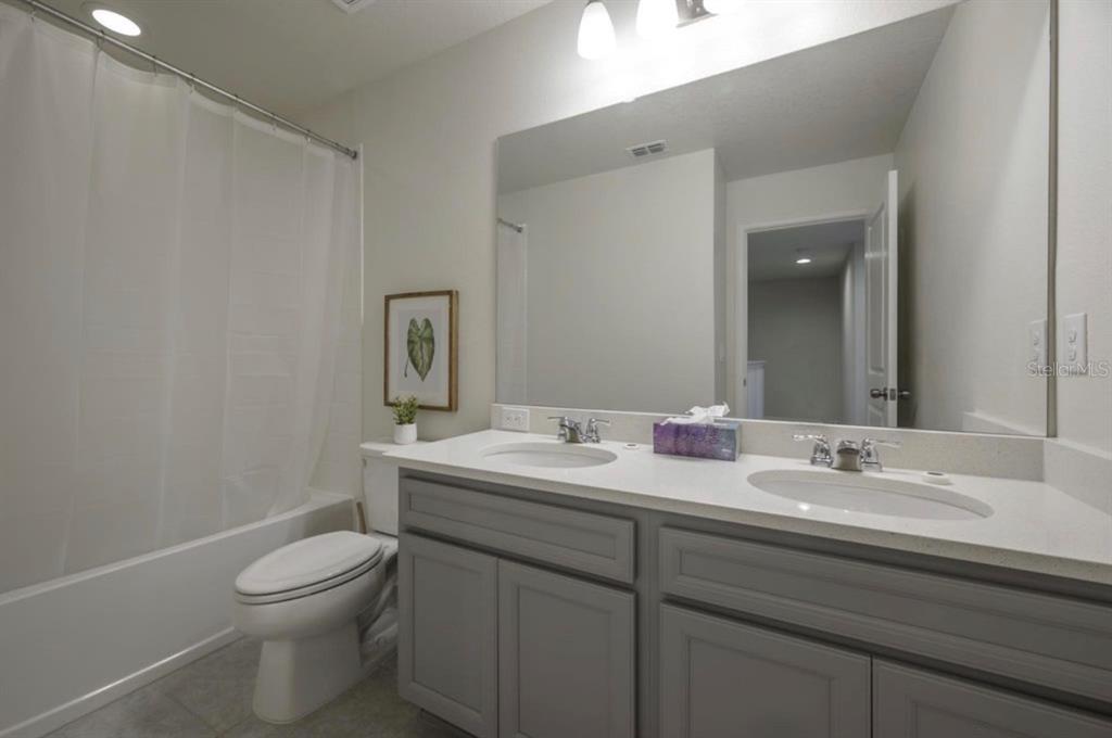 10128 Newel Valley Loop Riverview, FL 33569 - Photo 20 of 26 a bathroom with a toilet a sink and mirror