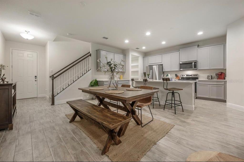 10128 Newel Valley Loop Riverview, FL 33569 - Photo 2 of 26 a living room with stainless steel appliances furniture a rug and a kitchen view