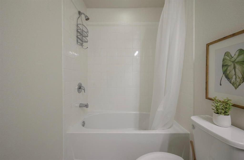 10128 Newel Valley Loop Riverview, FL 33569 - Photo 21 of 26 a bathroom with a shower curtain and toilet