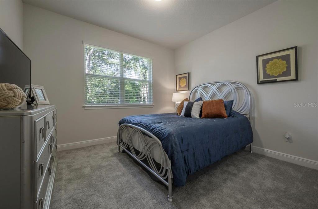 10128 Newel Valley Loop Riverview, FL 33569 - Photo 6 of 26 a bedroom with a bed and a window