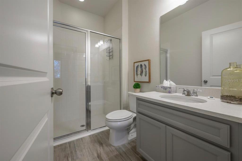 10128 Newel Valley Loop Riverview, FL 33569 - Photo 7 of 26 a bathroom with a granite countertop sink a toilet and shower