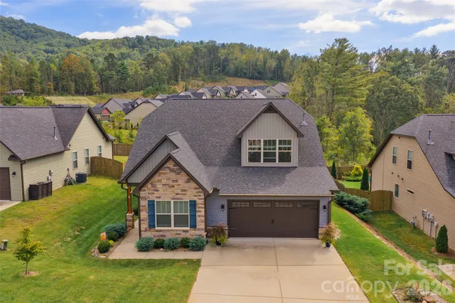 a aerial view of a house next to a yard