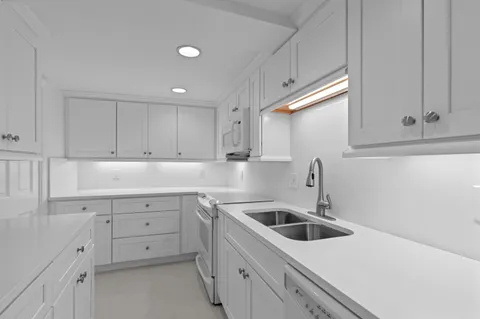 a kitchen that has a sink and cabinets