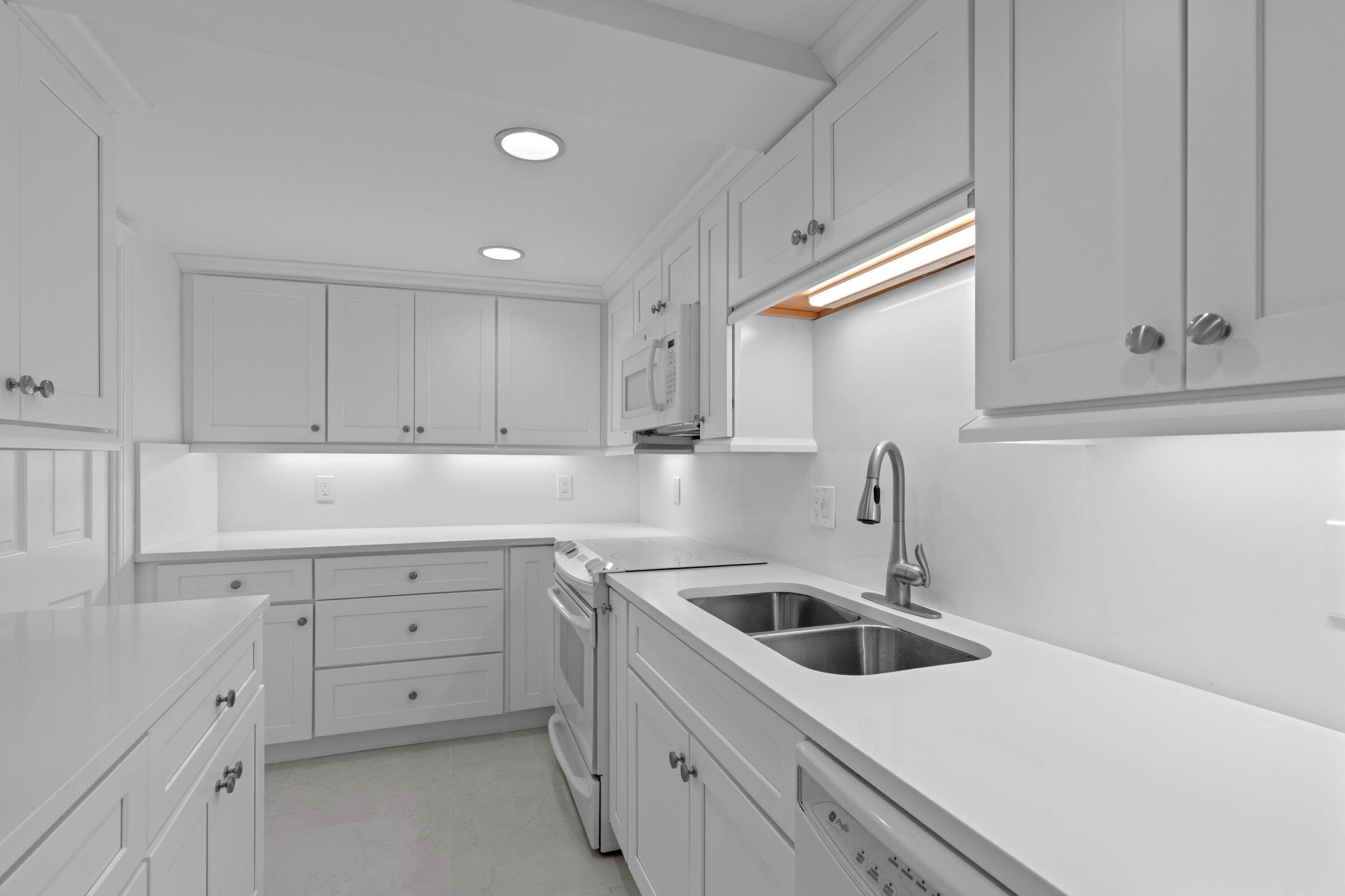 369 South Lake Drive, Unit 1D Palm Beach, FL 33480 - Photo 12 of 46 a kitchen that has a sink and cabinets