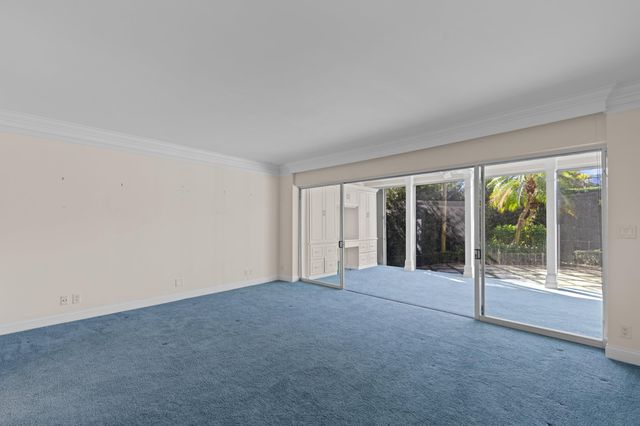 a view of an empty room with glass door