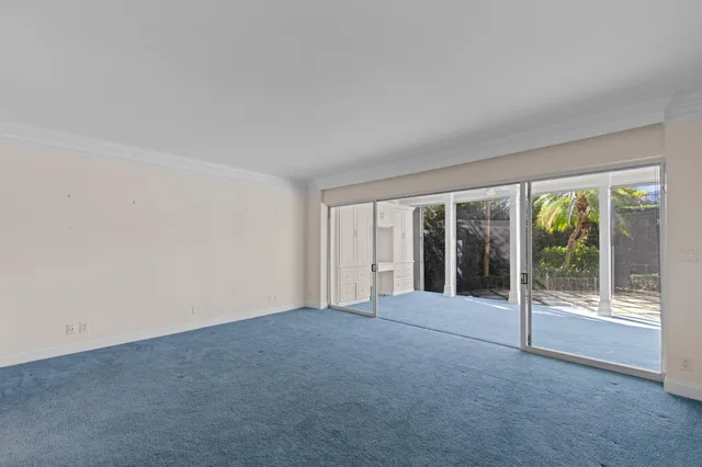 a view of an empty room with glass door