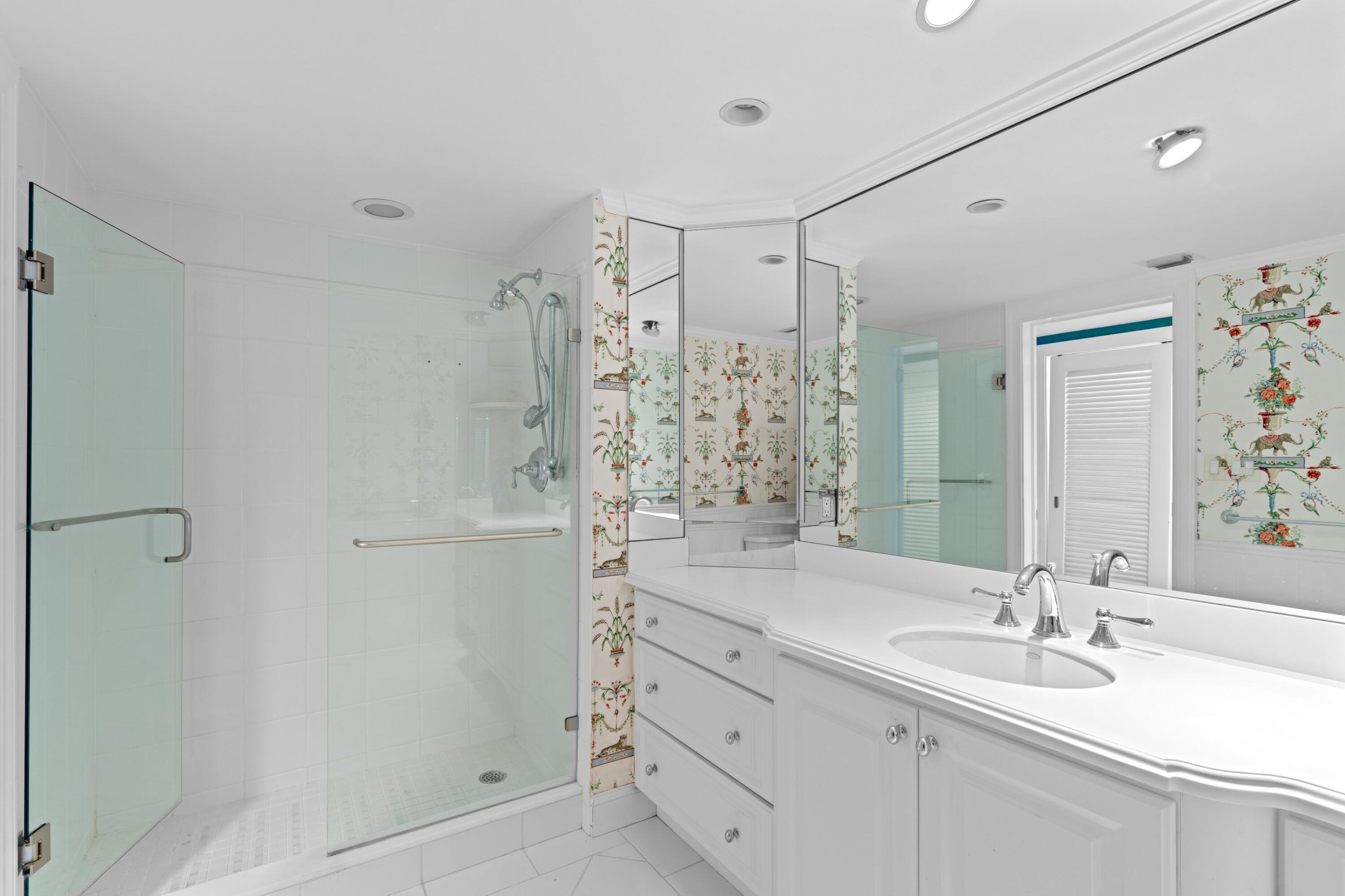 369 South Lake Drive, Unit 1D Palm Beach, FL 33480 - Photo 21 of 46 a bathroom with a shower sink vanity granite and shower