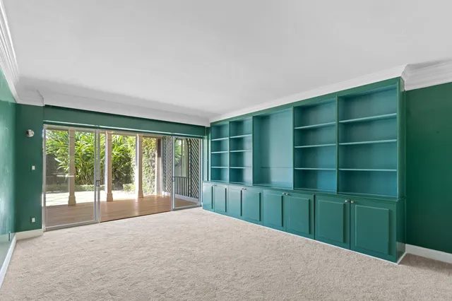 a view of an empty room with a window and balcony