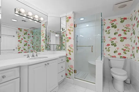 a bathroom with a sink toilet and shower