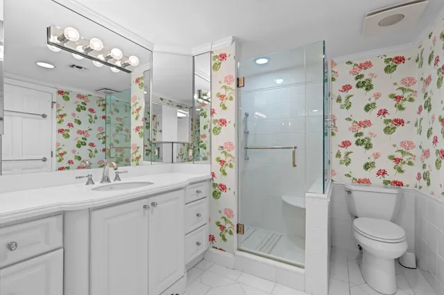 a bathroom with a sink toilet and shower