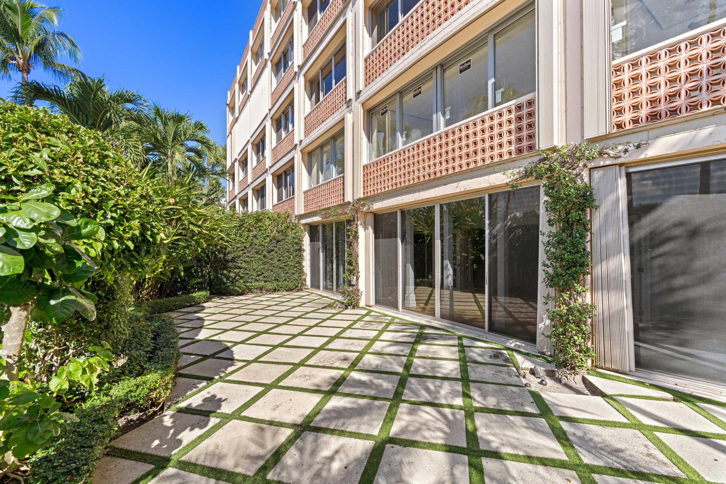 369 South Lake Drive, Unit 1D Palm Beach, FL 33480 - Photo 27 of 46 a view of a brick building next to a yard