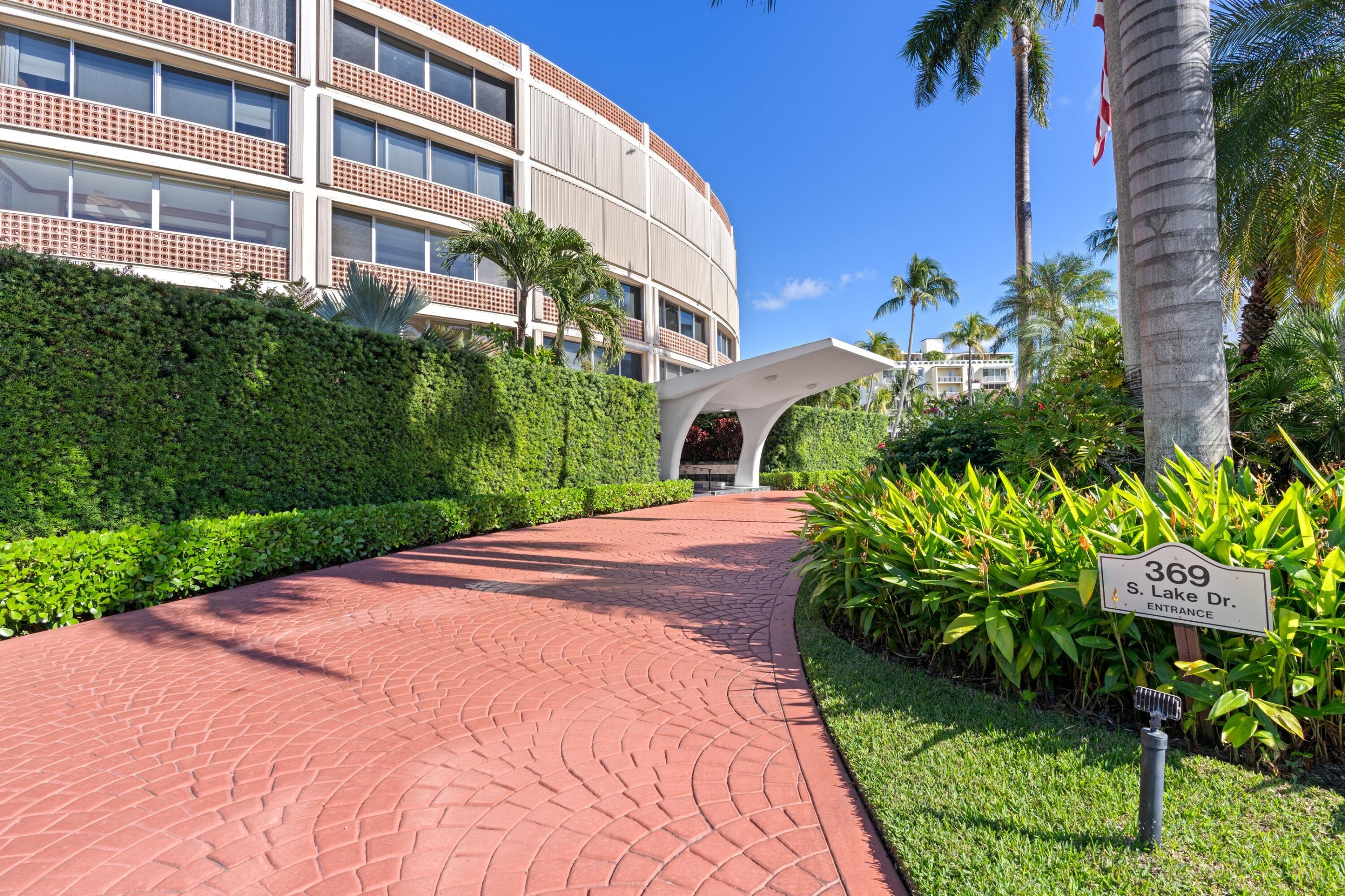 369 South Lake Drive, Unit 1D Palm Beach, FL 33480 - Photo 30 of 46 a front view of a multi story residential apartment building with yard and green space