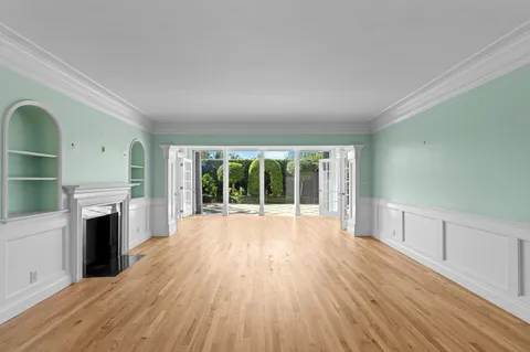wooden floor in an empty room with a fireplace