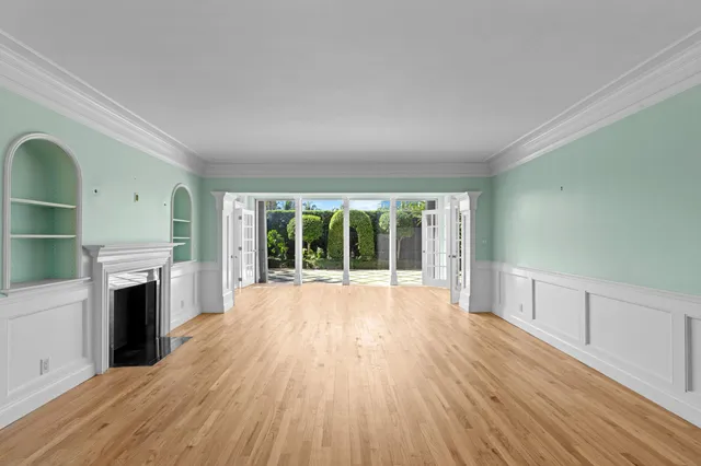 wooden floor in an empty room with a fireplace