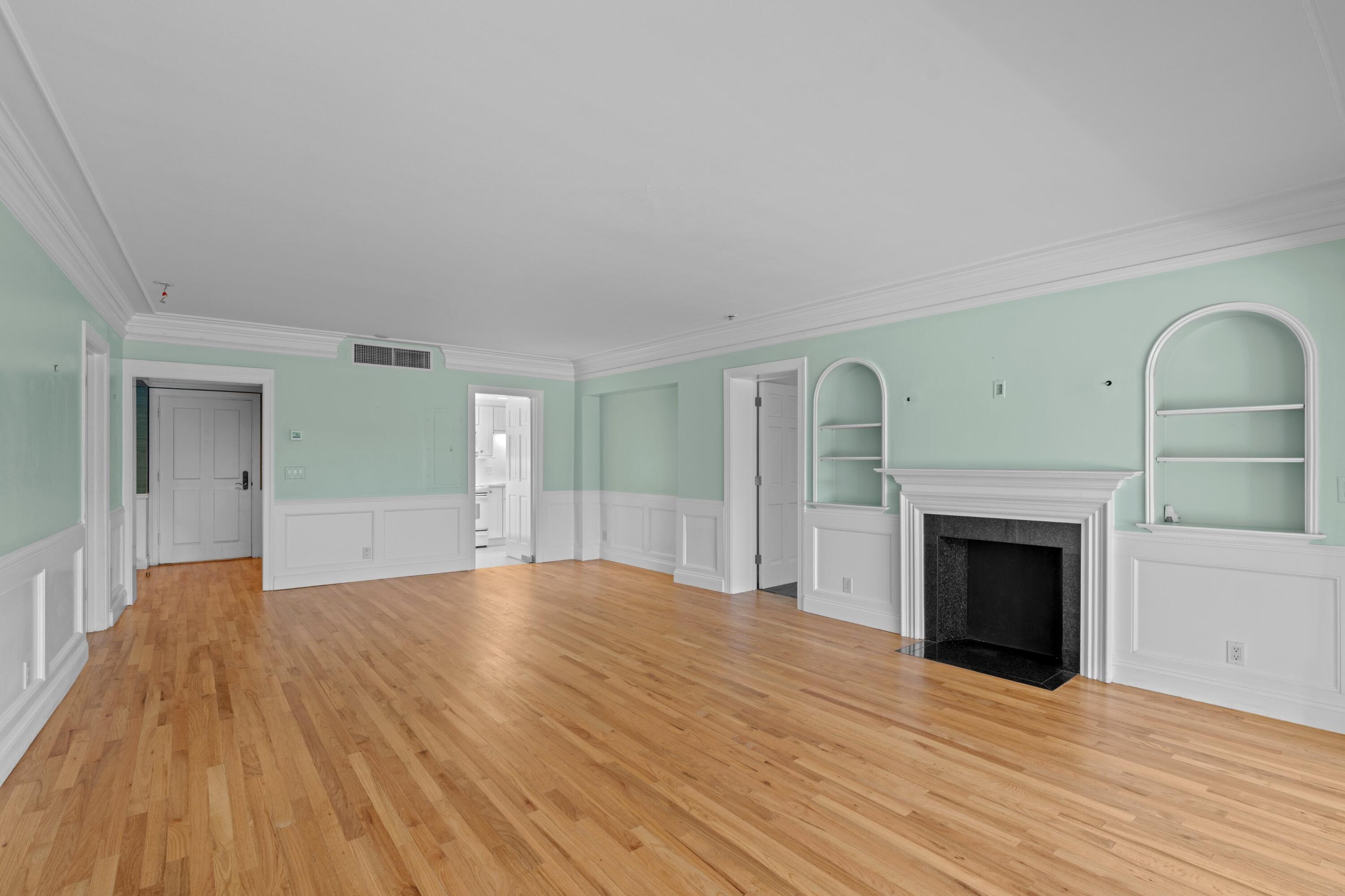 369 South Lake Drive, Unit 1D Palm Beach, FL 33480 - Photo 10 of 46 a view of empty room with wooden floor and fireplace