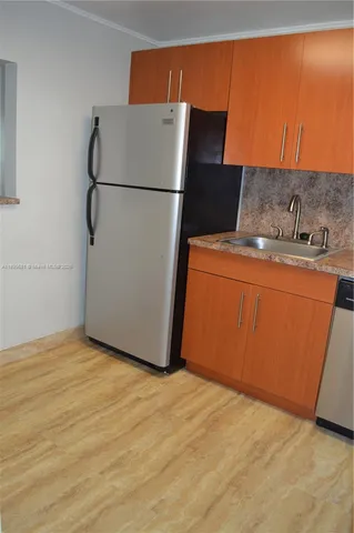 a white refrigerator freezer sitting in a kitchen