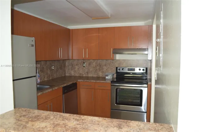 a kitchen with a stove and a refrigerator