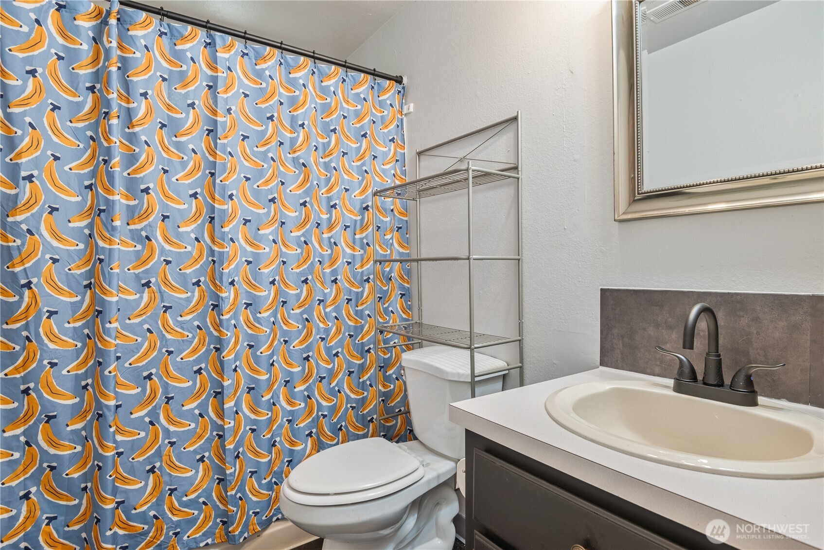 642 5th Avenue Southwest Castle Rock, WA 98611 - Photo 24 of 33 a bathroom with a sink a toilet and shower curtain