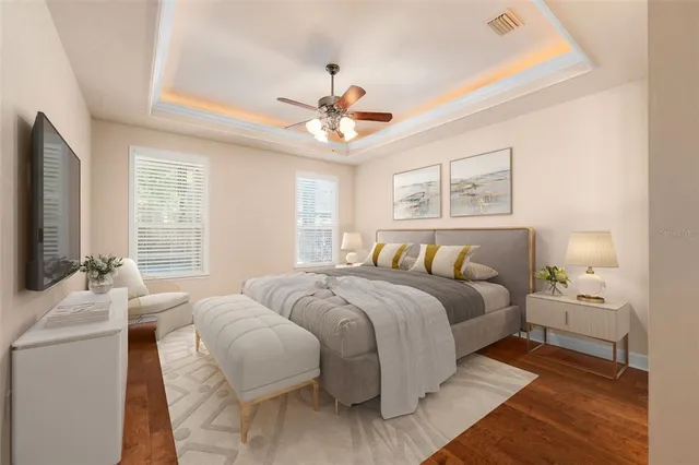 a bedroom with a large bed and a flat screen tv