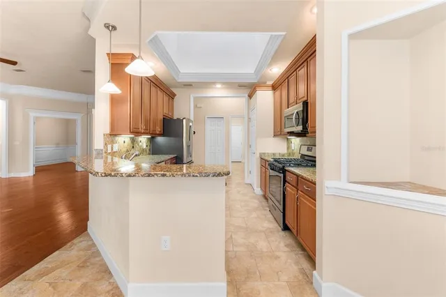 a kitchen with kitchen island a sink stove and cabinets