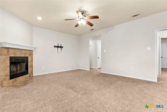 a view of an empty room with a fireplace
