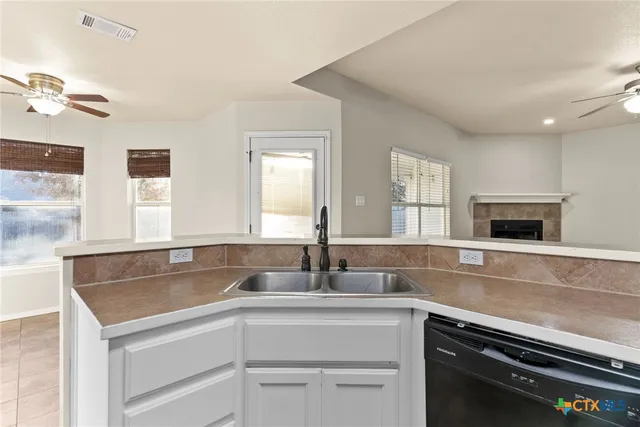a kitchen with granite countertop a sink and a stove