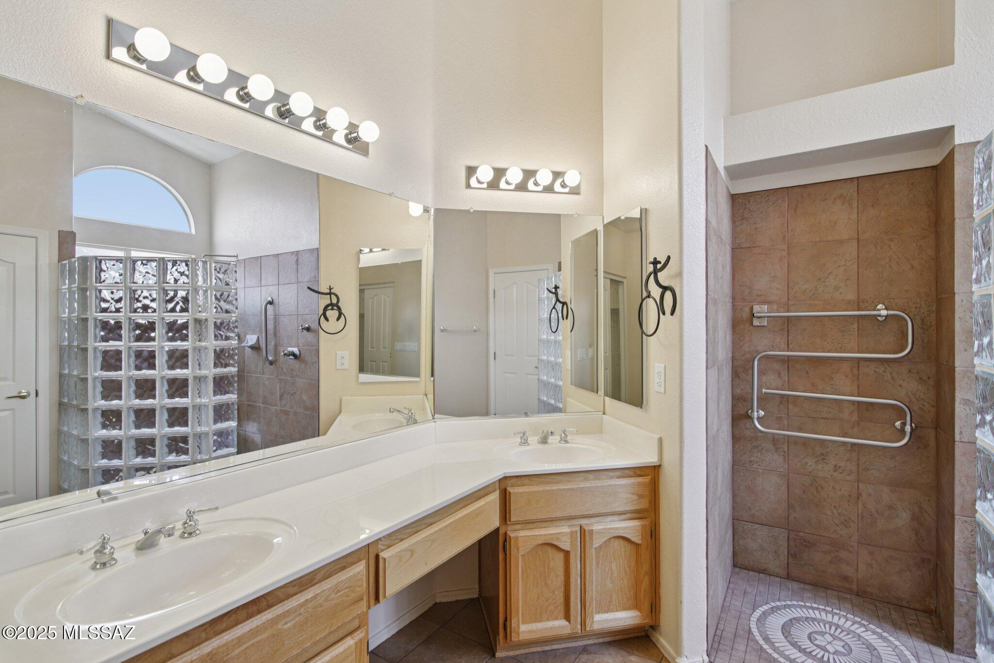 35890 Mesa Ridge Drive Tucson, AZ 85739 - Photo 16 of 31 a bathroom with a sink a toilet and shower
