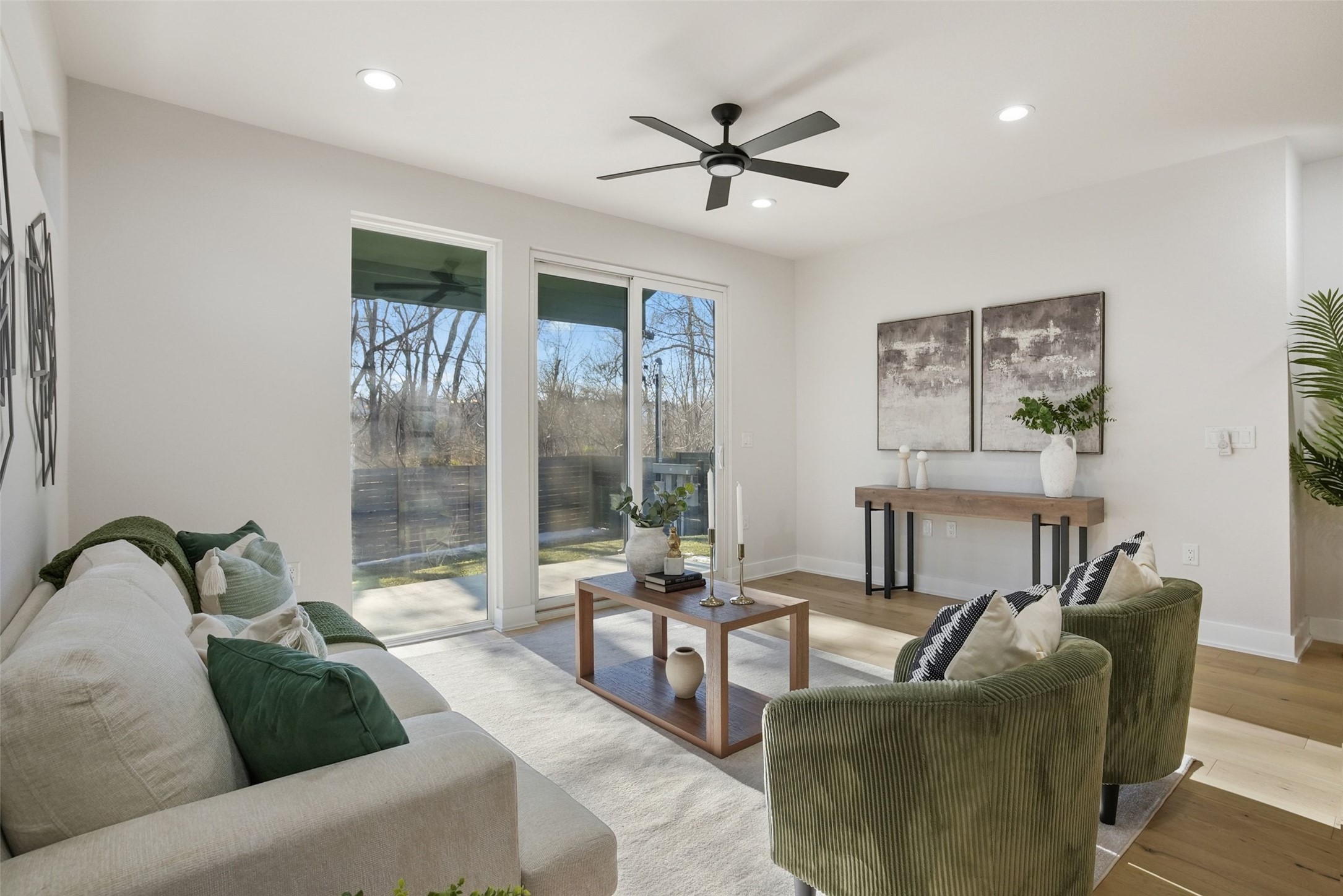 5109 Stone Gate Drive, Unit 2 Austin, TX 78721 - Photo 9 of 36 Spacious living area featuring large glass doors and windows, recessed lighting, a ceiling fan, and wood-finish flooring