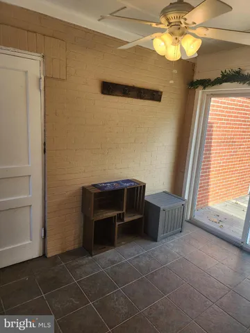 a living room with furniture wooden floor and a large window