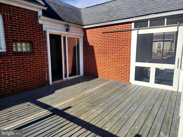 a living room with furniture a air conditioner vent and a window