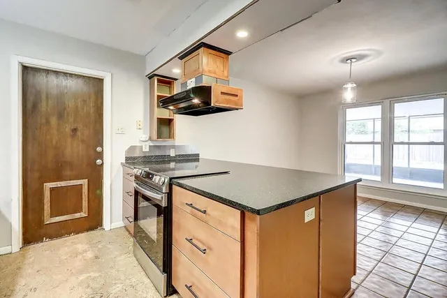 a kitchen that has a sink a stove and a refrigerator