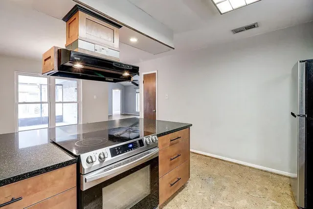 a kitchen with stainless steel appliances a stove and a refrigerator
