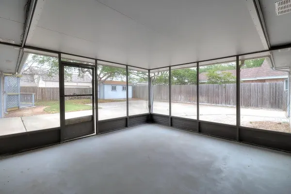 a view of an empty room with large windows