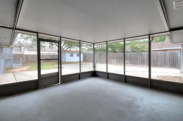 a view of an empty room with large windows