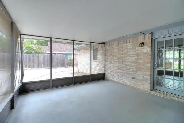 a view of an empty room with windows