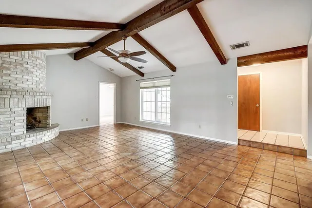 a view of an empty room with windows