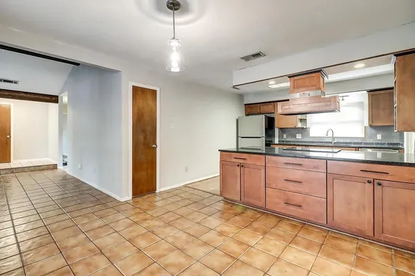 a kitchen with stainless steel appliances granite countertop a refrigerator and a sink