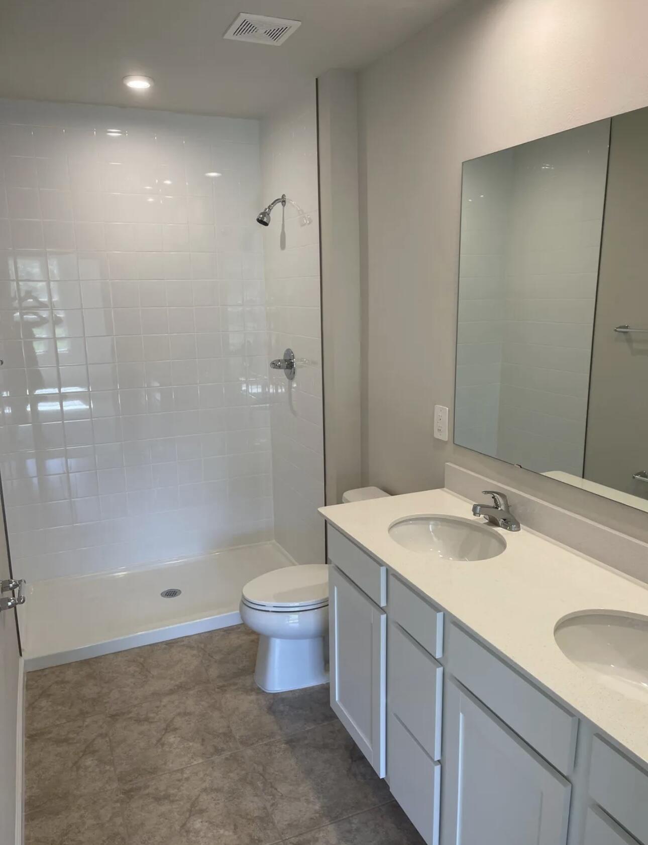 227 Raspberry Road Fort Pierce, FL 34981 - Photo 4 of 12 a bathroom with a sink a toilet and shower