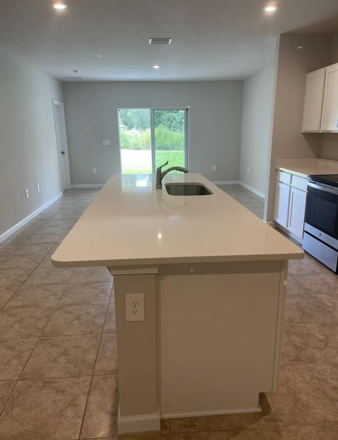 227 Raspberry Road Fort Pierce, FL 34981 - Photo 5 of 12 a kitchen with a sink and a stove