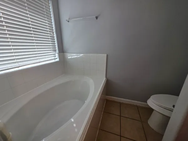 a bathroom with a bathtub and toilet
