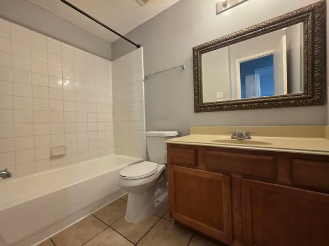 a bathroom with a sink mirror toilet and bathtub
