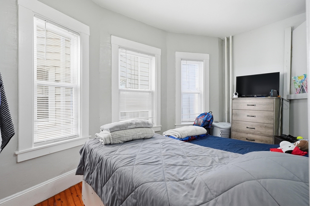 1661 North Shore Road Revere, MA 02151 - Photo 14 of 42 a bedroom with a bed and a flat screen tv