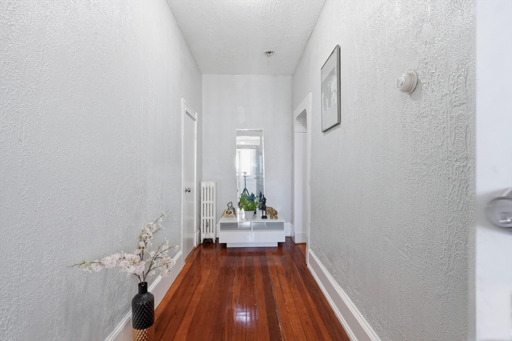 1661 North Shore Road Revere, MA 02151 - Photo 16 of 42 a view of a hallway with wooden floor and a bathroom