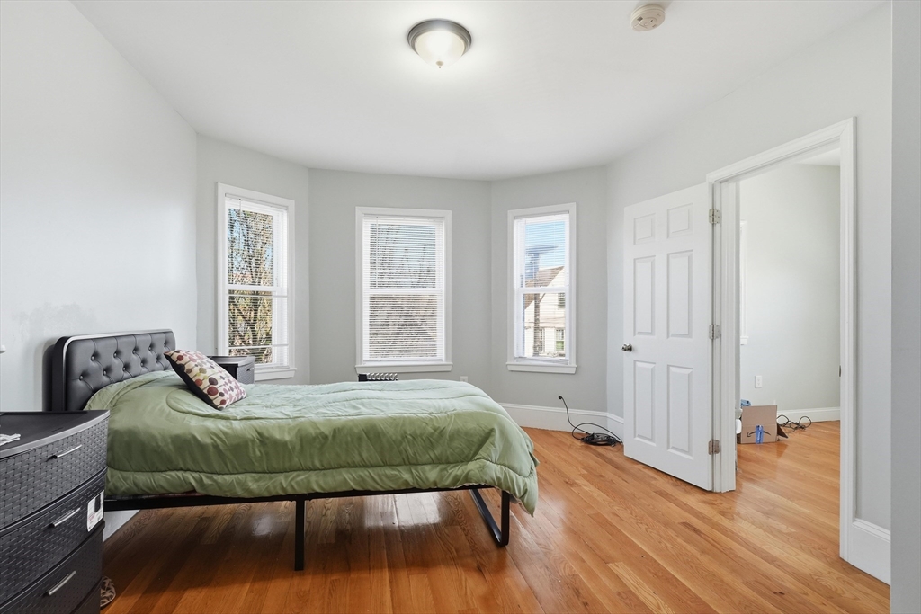 1661 North Shore Road Revere, MA 02151 - Photo 17 of 42 a bedroom with a bed and wooden floor