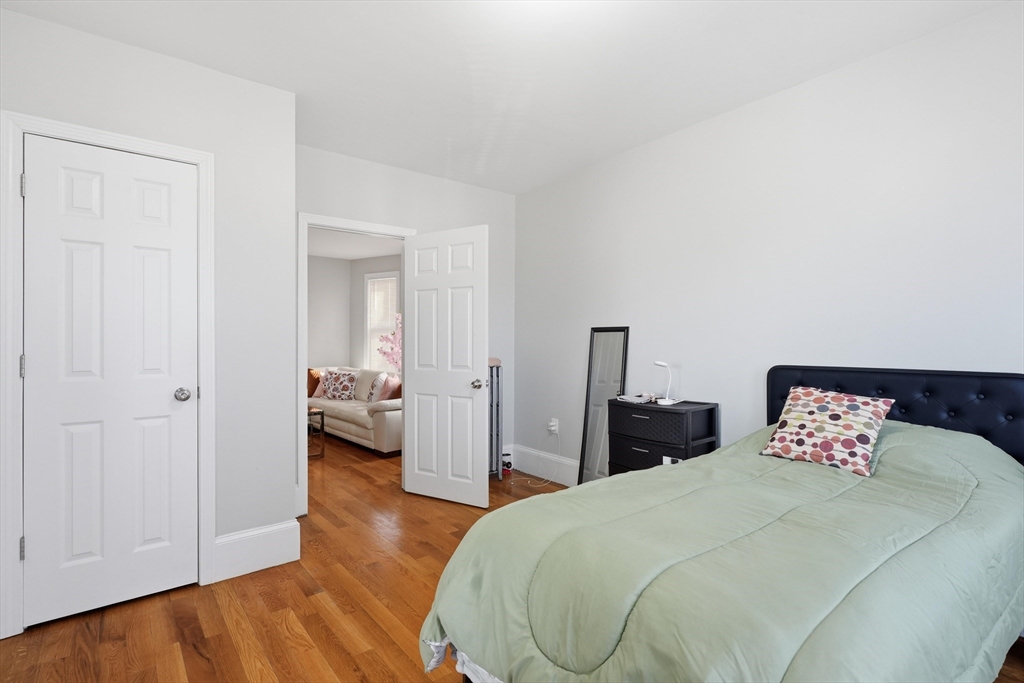 1661 North Shore Road Revere, MA 02151 - Photo 18 of 42 a bedroom with bed and wooden floor